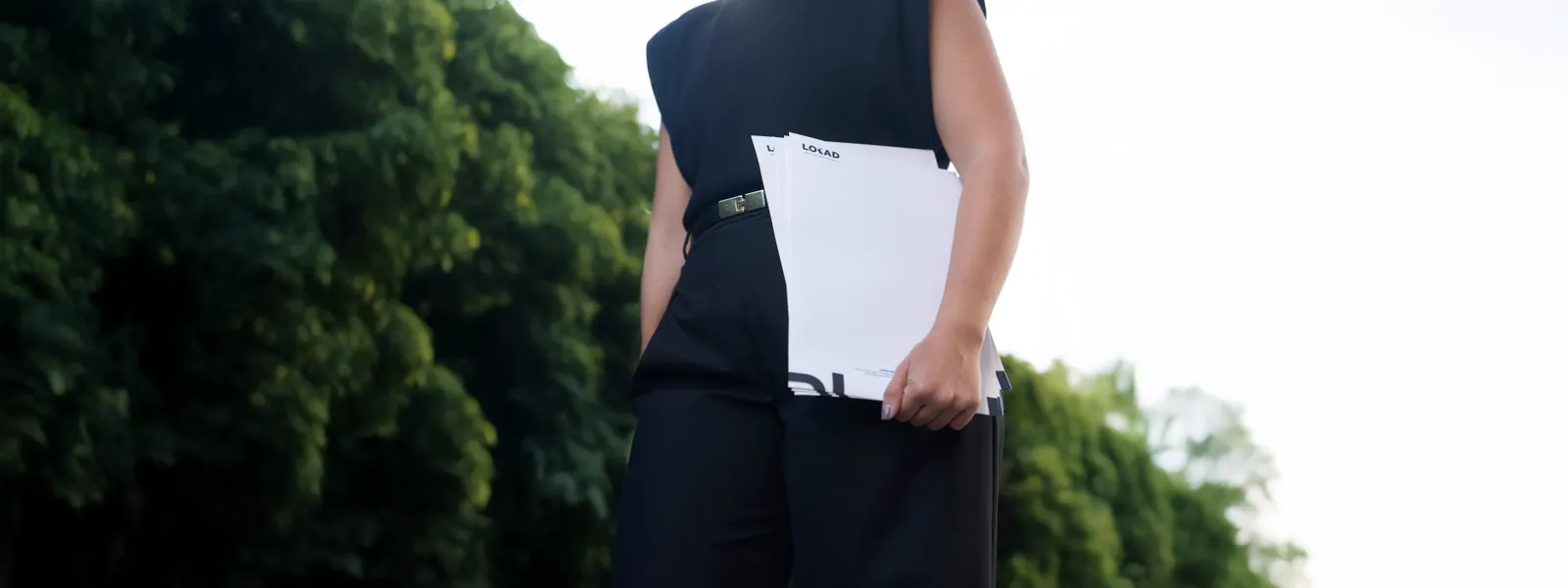 A LOKAD consultant holding LOKAD letterheads outdoors